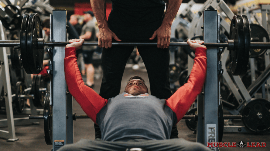 Getting a spotter during a bench press lift 