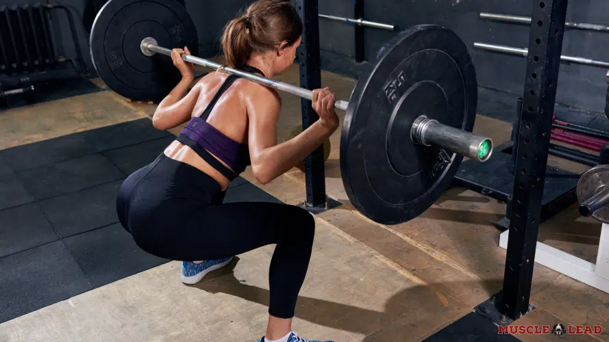 Female lifter performing back squat form and stance